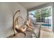 Covered outdoor space with hanging chairs, offering a cozy spot to relax and enjoy the pool view at 368 Ocean Course Ave, Davenport, FL 33896