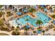 Aerial view of large community pool surrounded by palm trees, lounge chairs, and umbrellas at 368 Ocean Course Ave, Davenport, FL 33896