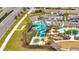Aerial view of the community water park with slides and a splash pad at 368 Ocean Course Ave, Davenport, FL 33896