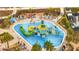 Aerial view of community water park with slides and splash pad providing a fun recreational space at 368 Ocean Course Ave, Davenport, FL 33896