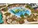 Aerial view of water park featuring colorful slides, splash pad, and lounge area for residents and guests at 368 Ocean Course Ave, Davenport, FL 33896