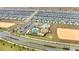 Aerial view of a community water park with pools, slides, and playground at 368 Ocean Course Ave, Davenport, FL 33896