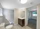 Bathroom featuring neutral paint colors, marble-look tile, glass enclosed shower, and a single sink vanity at 370 E Waldo St, Groveland, FL 34736