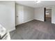 Bedroom featuring neutral paint colors, new carpet and baseboards with a walk-in closet at 370 E Waldo St, Groveland, FL 34736