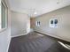 Spacious bedroom with gray carpet, neutral walls, ceiling fan and ample natural light from two windows at 370 E Waldo St, Groveland, FL 34736
