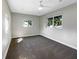Bright bedroom with gray carpet, natural light, ceiling fan and multiple windows offering views of neighborhood at 370 E Waldo St, Groveland, FL 34736