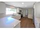 Bright kitchen featuring white cabinets, quartz countertops, stainless steel appliances and wood-look vinyl flooring at 370 E Waldo St, Groveland, FL 34736