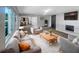 Bright living room features modern decor, fireplace, and seamless transition to the kitchen at 370 E Waldo St, Groveland, FL 34736