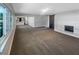 Open-concept living room features a fireplace, a modern sliding barn door, and seamless access to the kitchen at 370 E Waldo St, Groveland, FL 34736