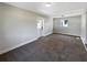 The living room features neutral paint colors, new carpet and a white painted back door at 370 E Waldo St, Groveland, FL 34736