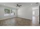 This bedroom features a ceiling fan, wood-look tile floors, and plenty of natural light at 3723 Broadway St, Gotha, FL 34734
