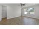 This bedroom features a ceiling fan, wood-look tile floors, and plenty of natural light at 3723 Broadway St, Gotha, FL 34734