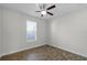 Bedroom features wood-look tile flooring and a window, offering a cozy and well-lit space at 3723 Broadway St, Gotha, FL 34734