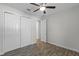 This bedroom includes wood-look tile flooring and a double closet with sliding doors, combining functionality and style at 3723 Broadway St, Gotha, FL 34734