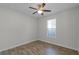 Cozy bedroom with wood-look tile flooring, ceiling fan, and natural light from the window, creating a peaceful retreat at 3723 Broadway St, Gotha, FL 34734