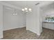 Bright dining room featuring modern light fixtures and wood-look tile flooring, perfect for gatherings at 3723 Broadway St, Gotha, FL 34734