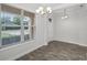 Bright dining area featuring wood-look tile flooring, large windows, and a modern chandelier at 3723 Broadway St, Gotha, FL 34734