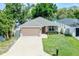 Lovely single-story home featuring a well-kept lawn, brick driveway, and convenient two-car garage at 3723 Broadway St, Gotha, FL 34734