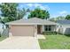 Charming single-story home with a well-manicured lawn, brick driveway, and an attached two-car garage at 3723 Broadway St, Gotha, FL 34734