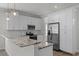 Modern kitchen featuring stainless steel appliances, granite countertops, and ample white cabinet space at 3723 Broadway St, Gotha, FL 34734