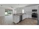 Modern kitchen with stainless steel appliances, white cabinets, granite countertops, and an open floor plan at 3723 Broadway St, Gotha, FL 34734