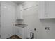 Functional laundry room equipped with storage cabinets, granite countertops, and sleek fixtures for convenience at 3723 Broadway St, Gotha, FL 34734