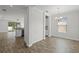 Open-concept living space featuring tile floors, modern lighting, and views of the kitchen and dining area at 3723 Broadway St, Gotha, FL 34734