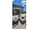 Inviting backyard with a brick fire pit, Adirondack chairs, and a covered patio at 402 Cool Summer Ln, Davenport, FL 33837
