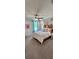 Bright and stylish bedroom with modern decor, ceiling fan, large window, and neutral carpeting at 402 Cool Summer Ln, Davenport, FL 33837