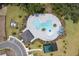 Aerial view of a resort-style community pool with lounge chairs, shaded areas, and a playground at 402 Cool Summer Ln, Davenport, FL 33837