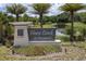 Horse Creek at Crosswinds entrance sign with lush landscaping, palm trees, and a tranquil pond in the background at 402 Cool Summer Ln, Davenport, FL 33837
