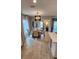 Open dining room area with a modern chandelier and views of the backyard at 402 Cool Summer Ln, Davenport, FL 33837