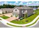 Two-story home with attached garage, brick paved driveway, professionally landscaped lawn, and beautiful corner lot at 402 Cool Summer Ln, Davenport, FL 33837