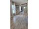 Bright hallway with wood-look tile flooring, stylish decor, and plenty of natural light at 402 Cool Summer Ln, Davenport, FL 33837
