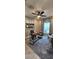 Bright home office featuring modern ceiling fan, window, decor, and stylish work space on decorative neutral toned carpeting at 402 Cool Summer Ln, Davenport, FL 33837