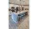 Spacious kitchen with white cabinets, quartz countertops, and a breakfast bar with pendant lighting at 402 Cool Summer Ln, Davenport, FL 33837