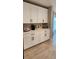Convenient kitchen beverage area with crisp white cabinets and counterspace at 402 Cool Summer Ln, Davenport, FL 33837