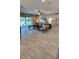 Cozy living room with neutral tones, stylish furniture, and sliding glass doors to the backyard at 402 Cool Summer Ln, Davenport, FL 33837