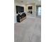 Cozy loft area with television, modern storage unit with baskets and neutral carpeting at 402 Cool Summer Ln, Davenport, FL 33837