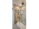 Tiled shower with glass door, rainfall shower head and sleek fixtures with adjacent tiled flooring at 402 Cool Summer Ln, Davenport, FL 33837