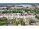 An aerial view captures homes in a wooded area near the highway and a lake at 432 Taylorville St, Deltona, FL 32725