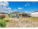 View of the home's backyard with a screen enclosed patio area at 432 Taylorville St, Deltona, FL 32725