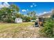 A well-maintained backyard with a storage shed and mature landscaping at 432 Taylorville St, Deltona, FL 32725