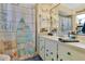 Coastal bathroom with a vanity, nautical-themed shower curtain, and beach accents, creating a relaxing atmosphere at 432 Taylorville St, Deltona, FL 32725