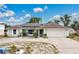 Charming one-story home with a circular driveway and solar panels on the roof at 432 Taylorville St, Deltona, FL 32725