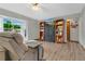 Comfortable living room featuring hardwood floors, built-in shelving, and a large window at 432 Taylorville St, Deltona, FL 32725