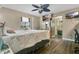Bright main bedroom features a ceiling fan, a tv, a walk-in bathroom, and ample natural light at 432 Taylorville St, Deltona, FL 32725