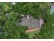 A bird's eye view of the home showcasing its landscaping, roof, and surrounding greenery of the community at 450 Andrews Dr, Longwood, FL 32750