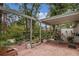 Cozy covered brick patio with outdoor seating, brick planter boxes and greenery for relaxing outdoors at 450 Andrews Dr, Longwood, FL 32750