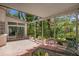 Picturesque covered brick patio with outdoor seating, greenery and an adjacent indoor space at 450 Andrews Dr, Longwood, FL 32750